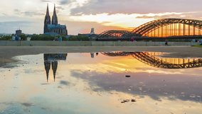 sunset at cologne cathedral, germany, reflecting in a puddle. shot on public ground, no pr necessary.