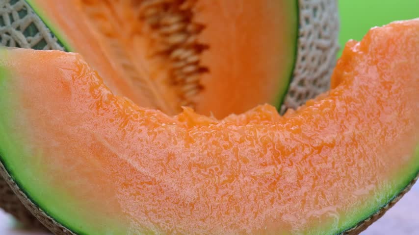 Fresh cantaloupe melon sliced on wooden