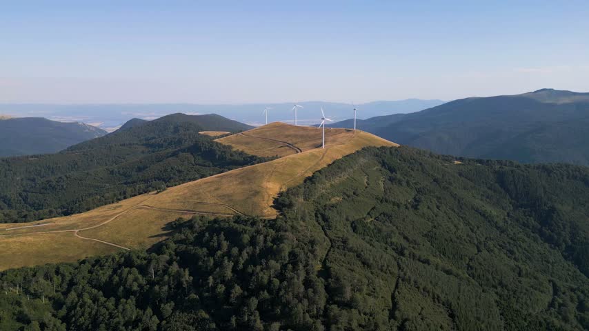 Aerial View of Wind Turbines Windmill Farm on Mountain Ridge at Sunset