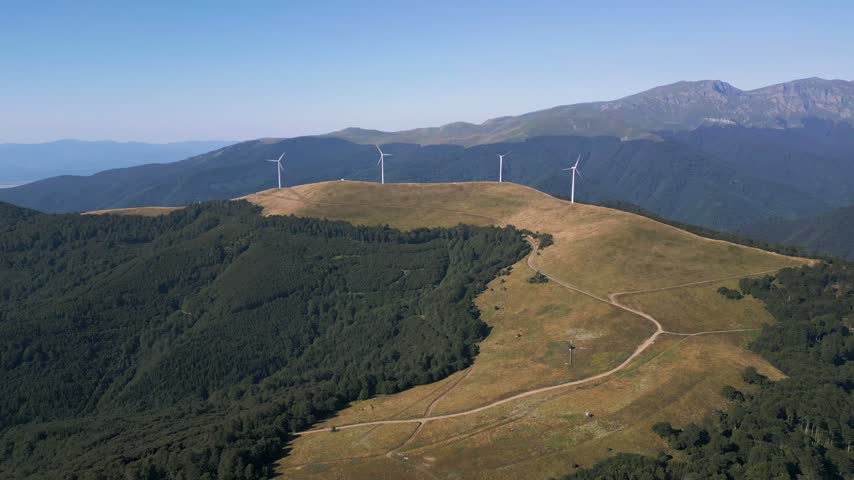Aerial View of Wind Turbines Windmill Farm on Mountain Ridge at Sunset