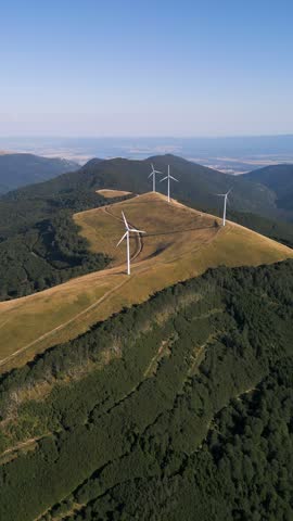 Aerial View of Wind Turbines Windmill Farm on Mountain Ridge at Sunset