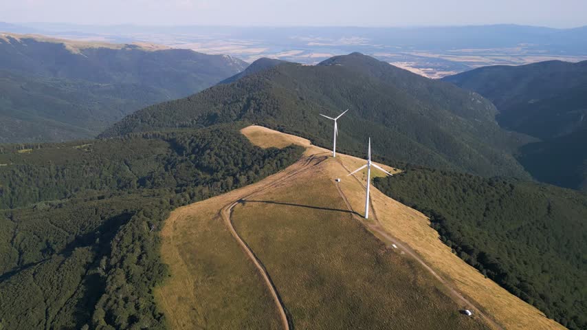 Aerial View of Wind Turbines Windmill Farm on Mountain Ridge at Sunset