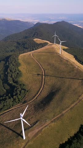 Aerial View of Wind Turbines Windmill Farm on Mountain Ridge at Sunset