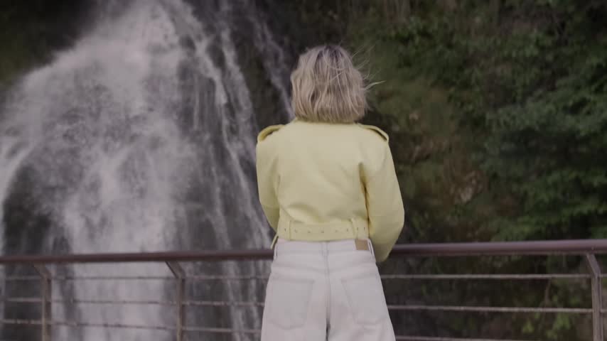 Female Tourist Watching Scenic Waterfall Near Lake Como Italy