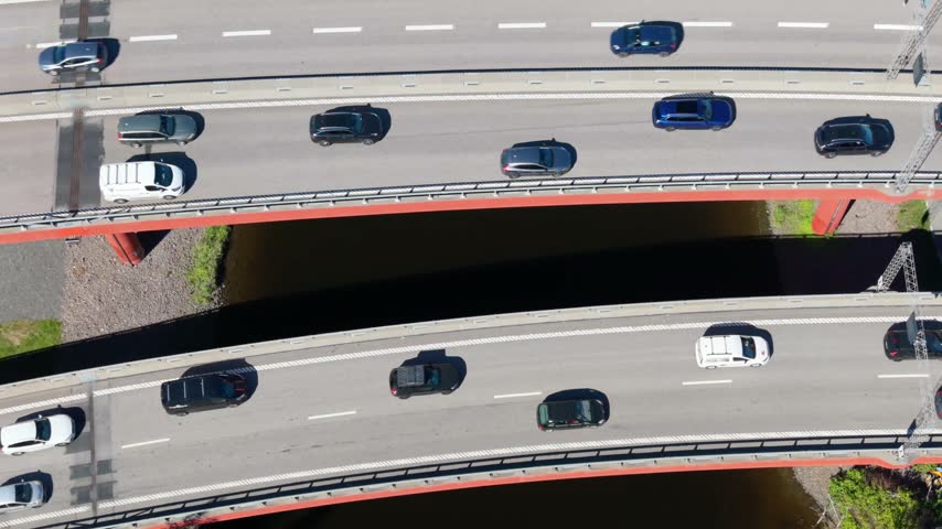 Aerial view of cars driving on a highway bridge over a river in Gothenburg, Vastra Gotaland County, Sweden.