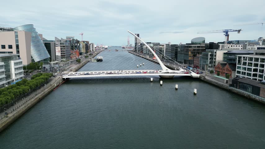 Drone pull back shot of modern Samuel Beckett Bridge in Dublin Ireland