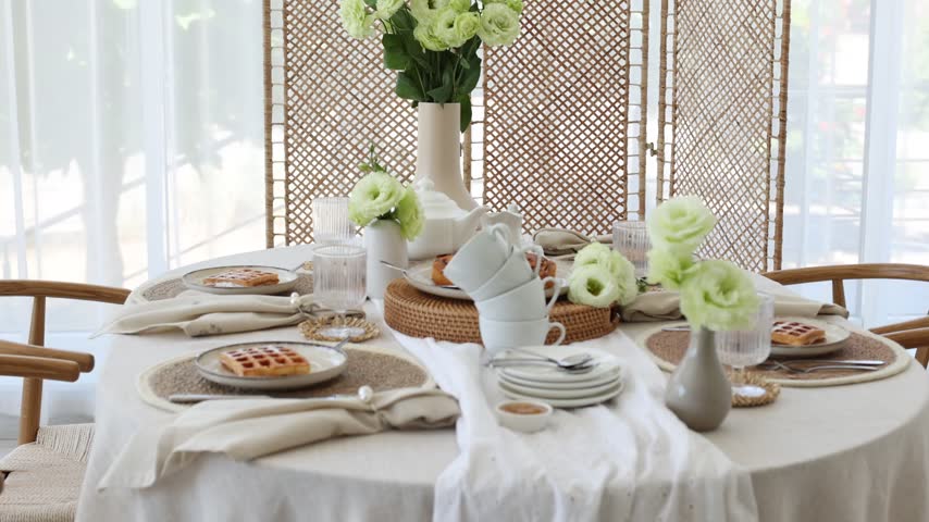 Beautiful table setting with flowers at home. Camera moving