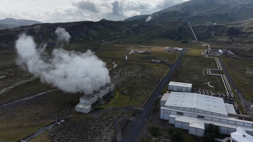 Aerial view of Nesjavellir Geothermal Power Station emitting steam over the volcanic landscape in Selfoss, Grimsnes- og Grafning, Iceland.