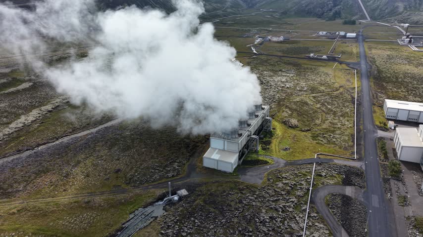 Aerial view of Nesjavellir Geothermal Power Station emitting steam over the volcanic landscape in Selfoss, Grimsnes- og Grafning, Iceland.
