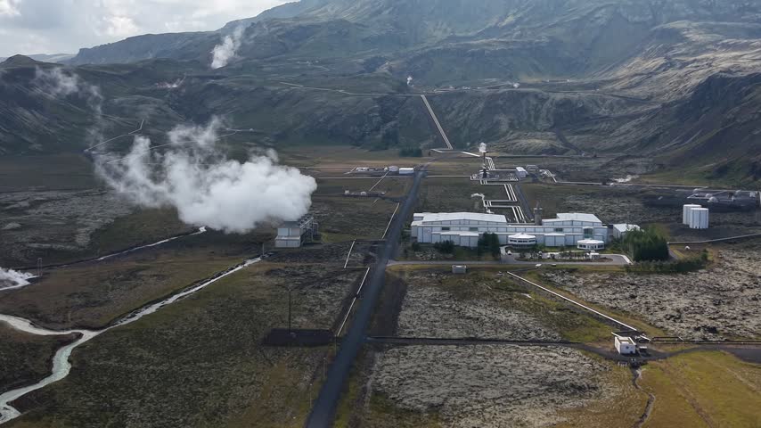 Aerial view of Nesjavellir Geothermal Power Station with steam rising from geothermal vents in the volcanic landscape of Selfoss, Grimsnes- og Grafning, Iceland.