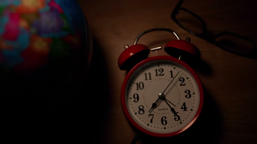 Vintage Red Alarm Clock with Globe and Glasses