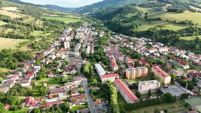 Aerial view of the town of Tisovec with residential buildings, green hills, and surrounding landscape in Tisovec, Banska Bystrica Region, Slovakia.
