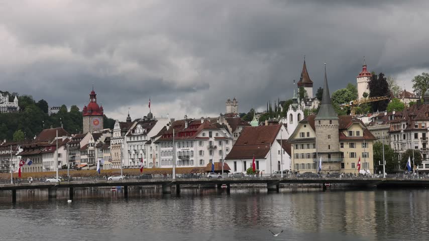 View of the historic Chapel Bridge and old town buildings along the Reuss river in Lucerne, Lucerne, Switzerland.