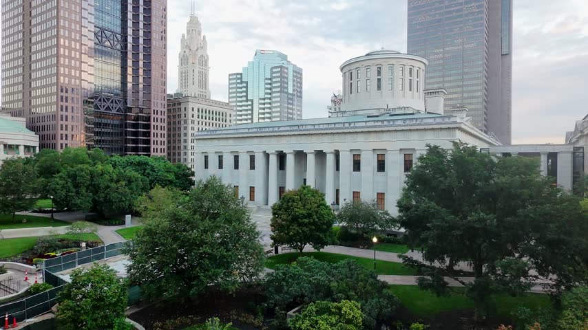 Drone shot of downtown Columbus in the early morning, capturing the Ohio Statehouse with the Columbus skyline