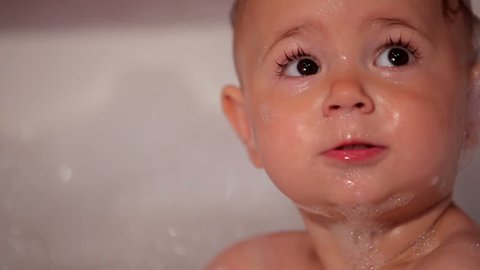 Little girl in bath with foam 