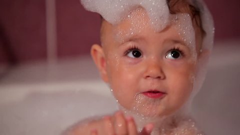 Little girl in bath with foam 