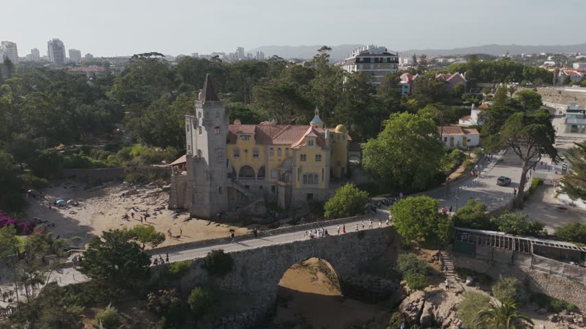 Aerial - Museu Condes De Castro Guimaraes Beside Its Stone Bridge And Small Beach In Cascais Portugal