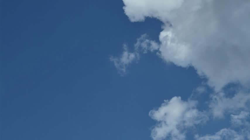The blue sky is Minimalist background minimalist with a  fluffy white cloud. Clean, bright blue sky featuring one soft, puffy white cloud floating gently. Perfect for designs, backgrounds, and copy space.