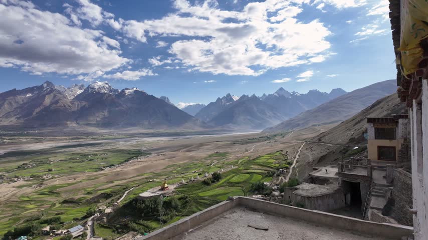 Zanskar, India : Panoramic aerial footage of Karsha Gompa, the largest Buddhist monastery in Padum of Zanskar valley in Ladakh, India showing golden stupas surrounded by beautiful mountain range landscape and river flows in the valley on sunny day