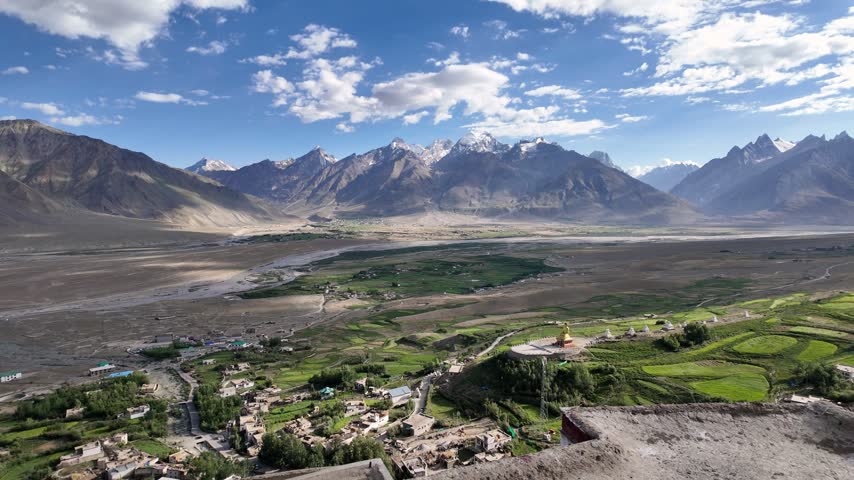 Zanskar, India : Panoramic aerial footage of Karsha Gompa, the largest Buddhist monastery in Padum of Zanskar valley in Ladakh, India showing golden stupas surrounded by beautiful mountain range landscape and river flows in the valley on sunny day