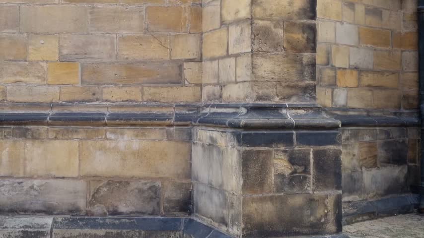 The Gothic facade and spires of St. Vitus Cathedral tower above visitors inside Prague Castle