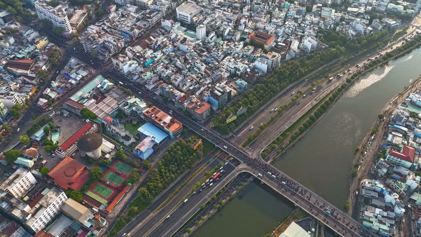 Top down aerial hyperlapse of busy traffic on Nguyen Tri Phuong Bridge and Vo Van Kiet Boulevard, District 5, Ho Chi Minh City, Vietnam at morning