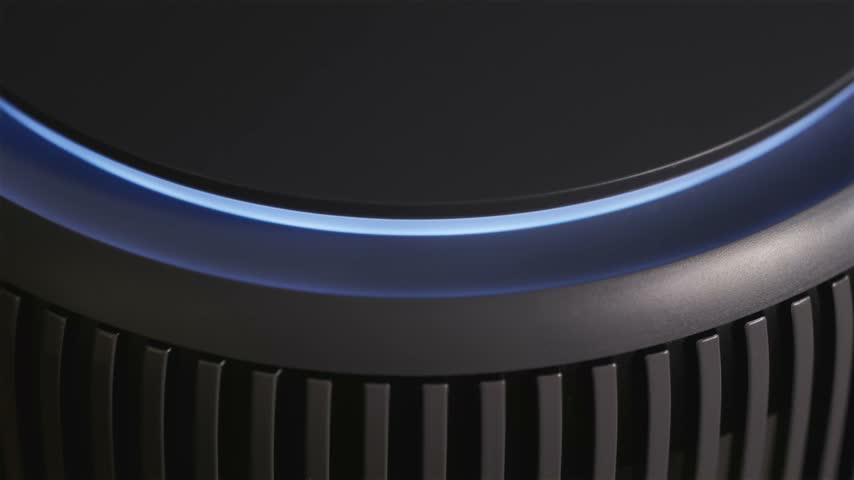 Cinematic macro shot of smart air cleaner sensor light switching from yellow to blue color, indicating clean air quality in modern room.