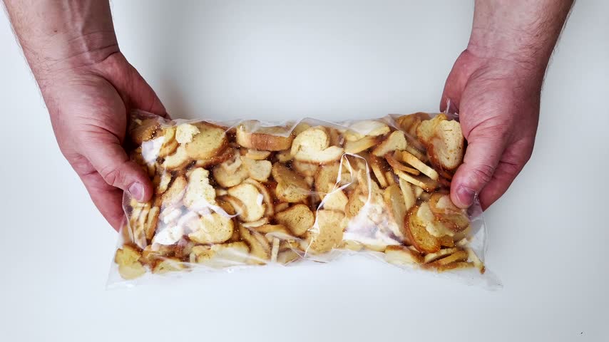 Assortment of mixed nuts and dried fruit laid out on a clean white surface, perfect for healthy snacking or baking ingredients, vibrant natural colors