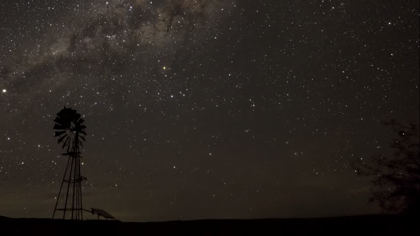 Milky Way Galactic Center moving behind farm windmill