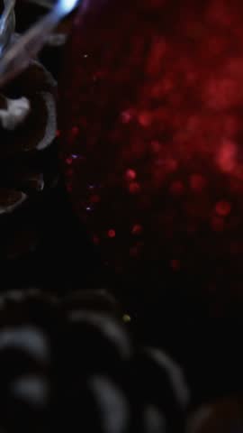 Animation of glowing lights moving over fir tree cones christmas decorations. christmas, tradition and celebration concept digitally generated video.