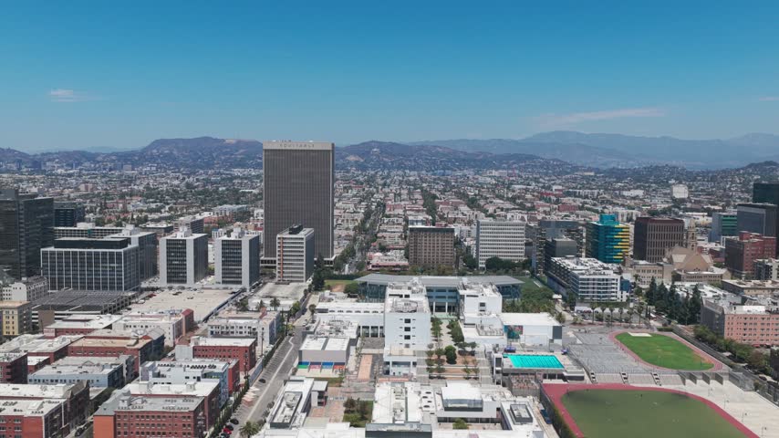 Wide aerial dolly shot of the historic Wilshire Center district in the Koreatown neighborhood of Los Angeles, California. 4K