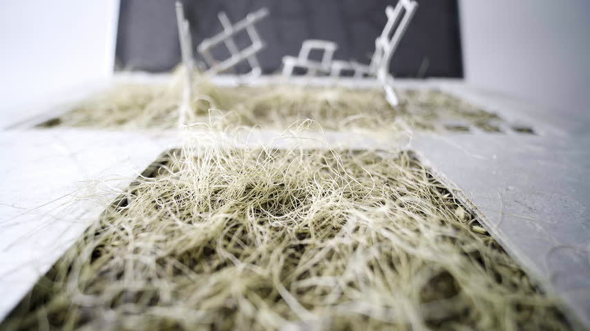 Post apocalyptic laptop reclaimed by nature with dried grass and No War message
