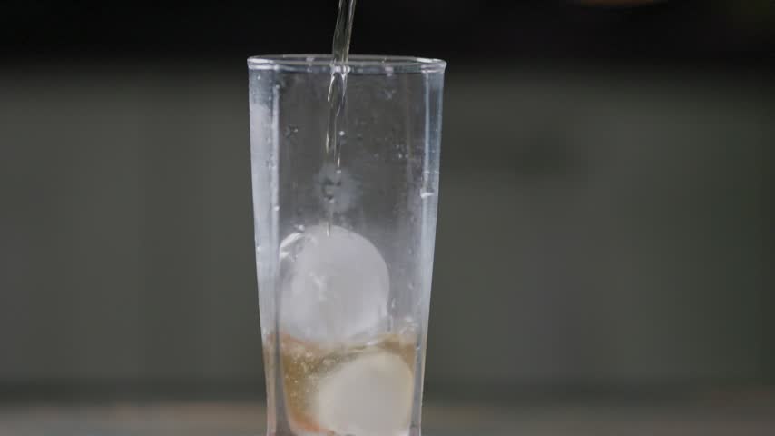 Pouring Fresh Peach Extract Juice Over Ice Cubes Close Up Slow Motion.
Close-up slow motion shot of fresh peach extract juice pouring over ice cubes in a glass. Detailed view of the flowing peach beverage contacting the ice, with bubbles and liquid movement visible around the ice. Ideal for refreshing summer beverage, fruit drink, food, commercial, advertising, and lifestyle projects.
