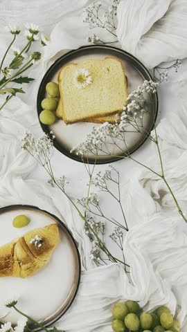 Toasted Bread Slices with Green Grapes and White Flowers on Round Plate