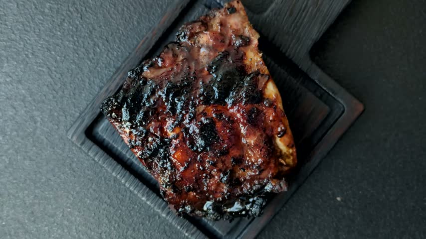 Grilled or barbecued pork or beef ribs, meat with red sauce for the dinner table. Grilled ribs