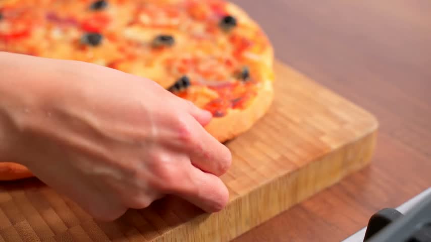 Beautiful kitchen video with homemade round pizza with 
vegetables, meat, olive, tomato, cheese, 
mayonnaise. Appetizing tasty dish.