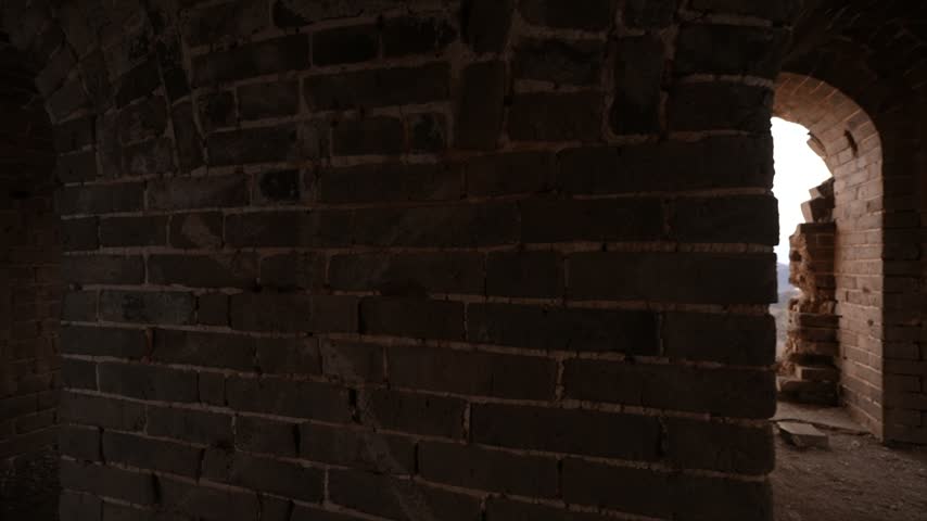 Inside view of a watch tower on the Great Wall of China showing an old window and the landscape.