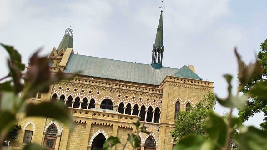 Frere Hall in Karachi Pakistan Viewed Through Green Plants, Historic Colonial Architecture and Famous Cultural Heritage Landmark – 4K Footage