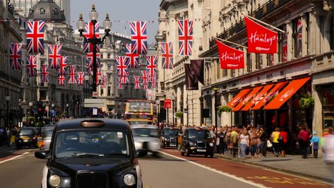 LONDON - CIRCA 2012 - London, Regent Street, Decorated with Union Jack Flags marking the Royal Wedding of Prince William and Kate Middleton, London Taxi and Buses. Time lapse T/L
