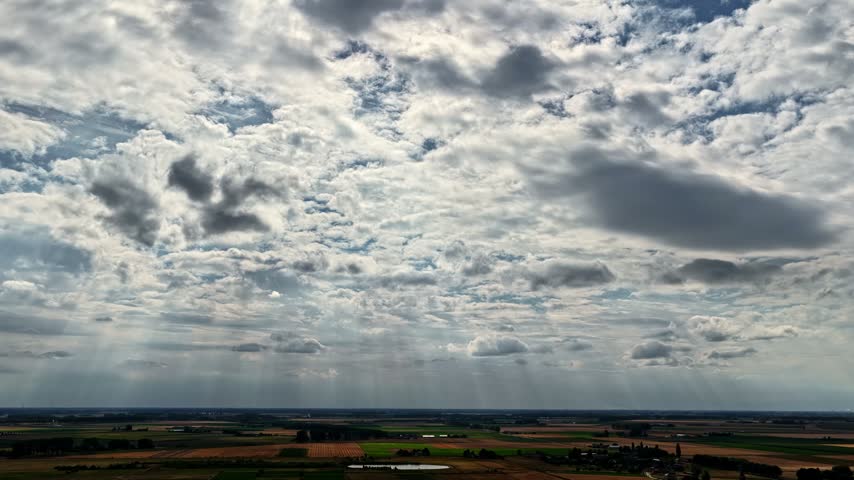 Aerial view of Doel Nuclear Power Plant surrounded by agricultural fields under a dramatic cloudy sky in Beveren-Kruibeke-Zwijndrecht, Vlaanderen, Belgium.