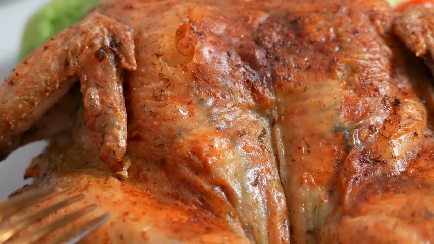 Slicing of baking in the oven homemade bird - chicken or turkey. Festive tasty dinner for thanksgiving day or 
christmas. Beautiful kitchen video. Appetizing meat dish.