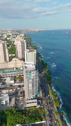 Coastal Buildings And Traffic In Avenida George Washington, Malecon By The Caribbean Sea In Santo Domingo, Dominican Republic. - aerial vertical shot