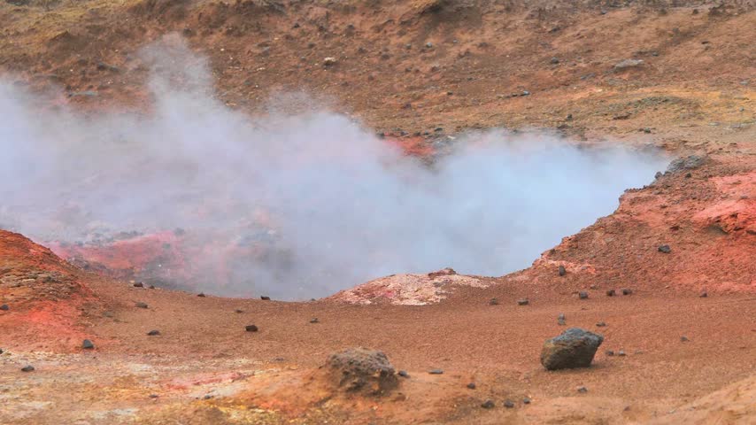 Steaming fumaroles and sulfur vents at Hverir geothermal area near Námafjall and Lake Mývatn, North Iceland. Close-up video of bubbling mud pots, colorful volcanic soil, and rising geothermal steam.