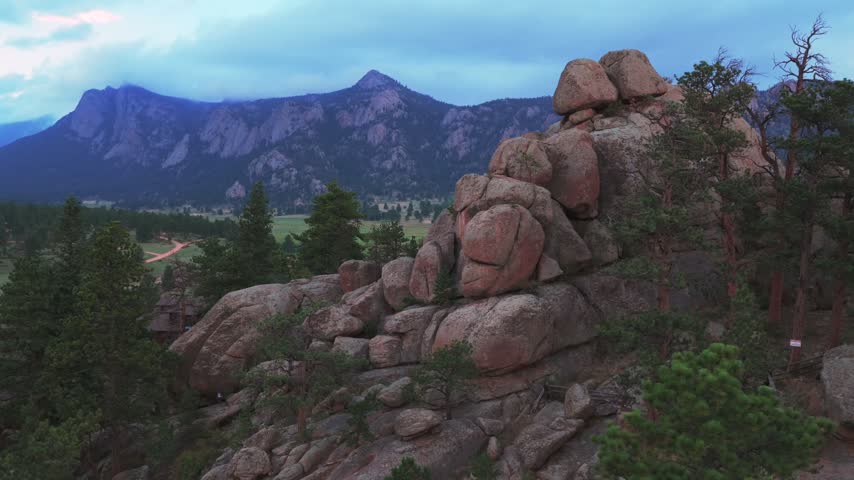 Estes Park summertime afternoon rain clouds sunset Black Canyon Creek Balanced Rock landscape aerial drone Colorado Front Range Rocky Mountains National Park valley circle right motion