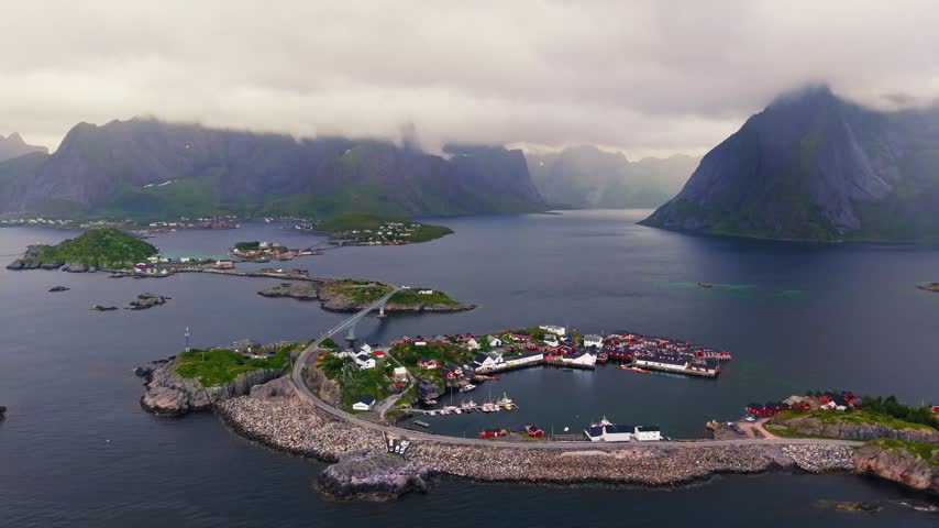Aerial view of Hamnøy fishing village and the scenic E10 road crossing bridges between rocky islands in the Lofoten archipelago, Northern Norway