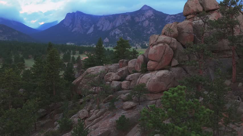 Estes Park summertime afternoon rain clouds sunset Black Canyon Catering Balanced Rock landscape aerial drone Colorado The Needles Emerald Mountain Front Range Rocky Mountains forward pan up motion