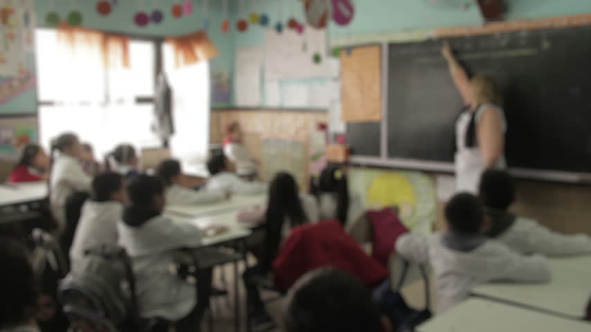 Blurred Classroom Background Of Argentine Public School With Students And Teacher