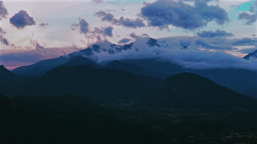 Estes Park Front Range Rocky Mountains view of Longs Peak aerial drone parallax Colorado RMNP Rocky Mountain National Park landscape landmark sunset low rain clouds summer golden blue hour upwards