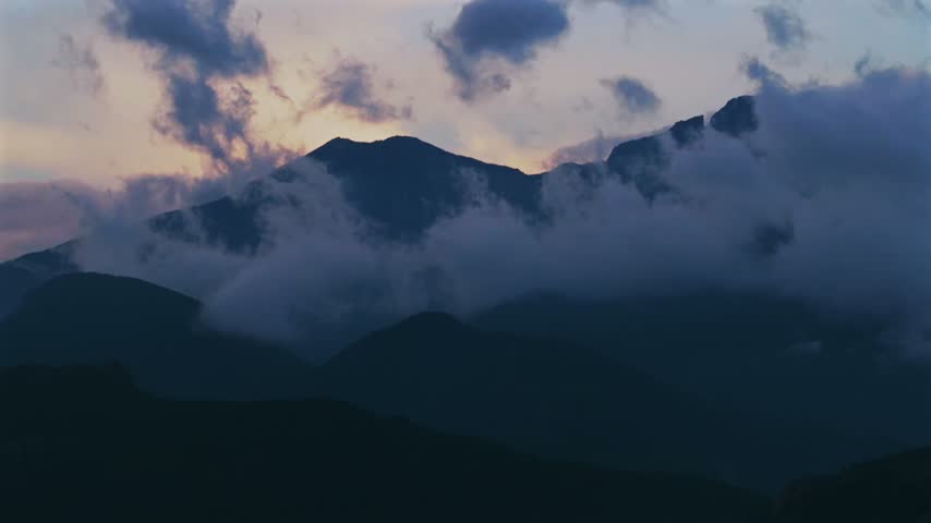 Estes Park Front Range Rocky Mountains view of Longs Peak aerial drone parallax Colorado RMNP Rocky Mountain National Park landscape sunset low rain clouds summer golden blue hour circle left motion
