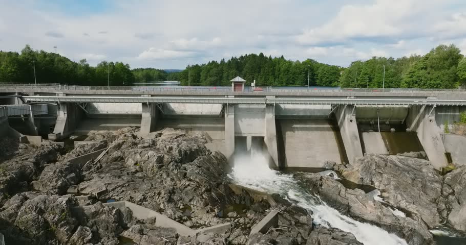 Hydroelectric dam at Rykene with water flow and rocky landscape in slow motion showing cascade